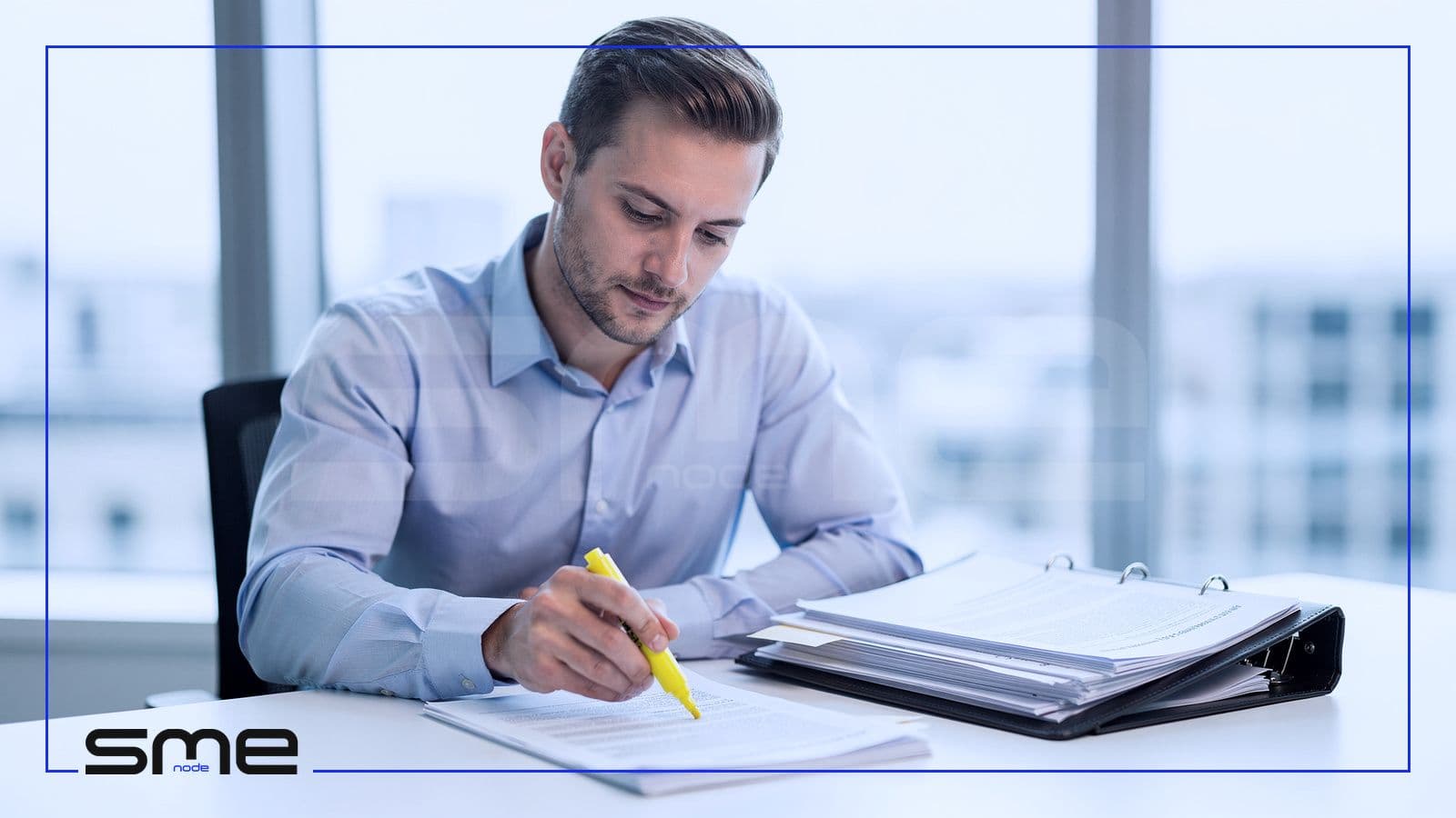 Compliance officer highlighting printed privacy regulation documents beside a binder to work out which Canadian rules apply to the company's AI