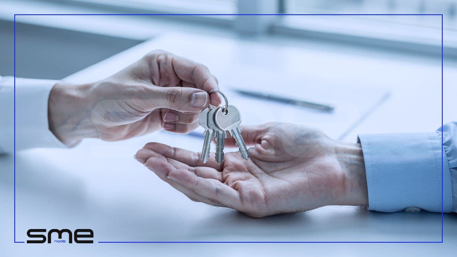 One hand passes a ring of office keys into another open hand above a desk, the written hand-over of accountability to a part-time CIO