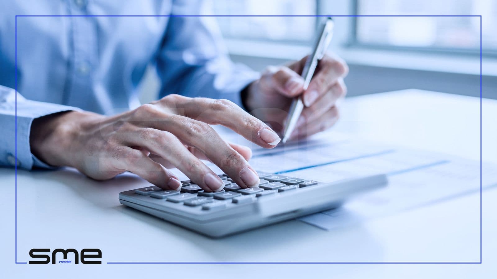 Close-up of hands working a calculator next to a printed budget sheet, representing the cost of AI strategy consulting in Canada