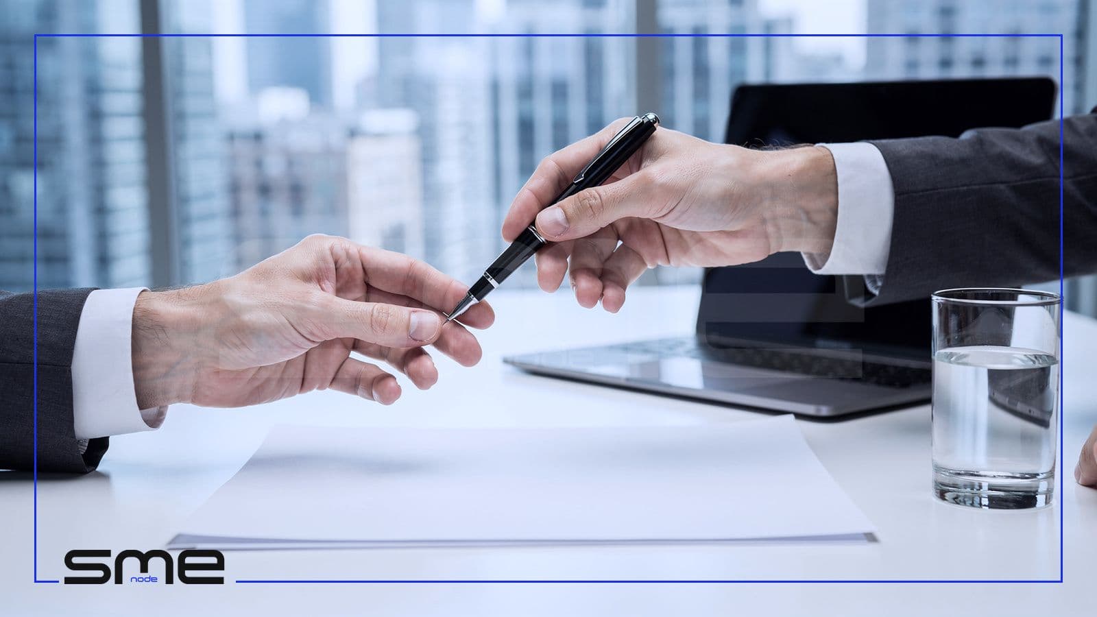 One business person handing a pen to another over a blank contract, representing the Business Associate Agreement that brings HIPAA to a Canadian vendor with US clients
