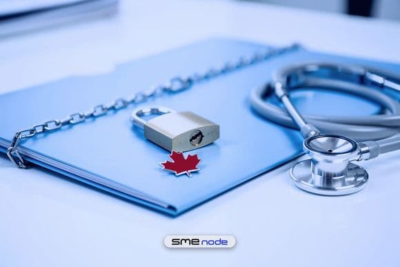 A light-blue patient file folder locked with a chain and brass padlock, a red maple leaf pin on its cover and a stethoscope beside it, for Canadian health privacy law in place of HIPAA