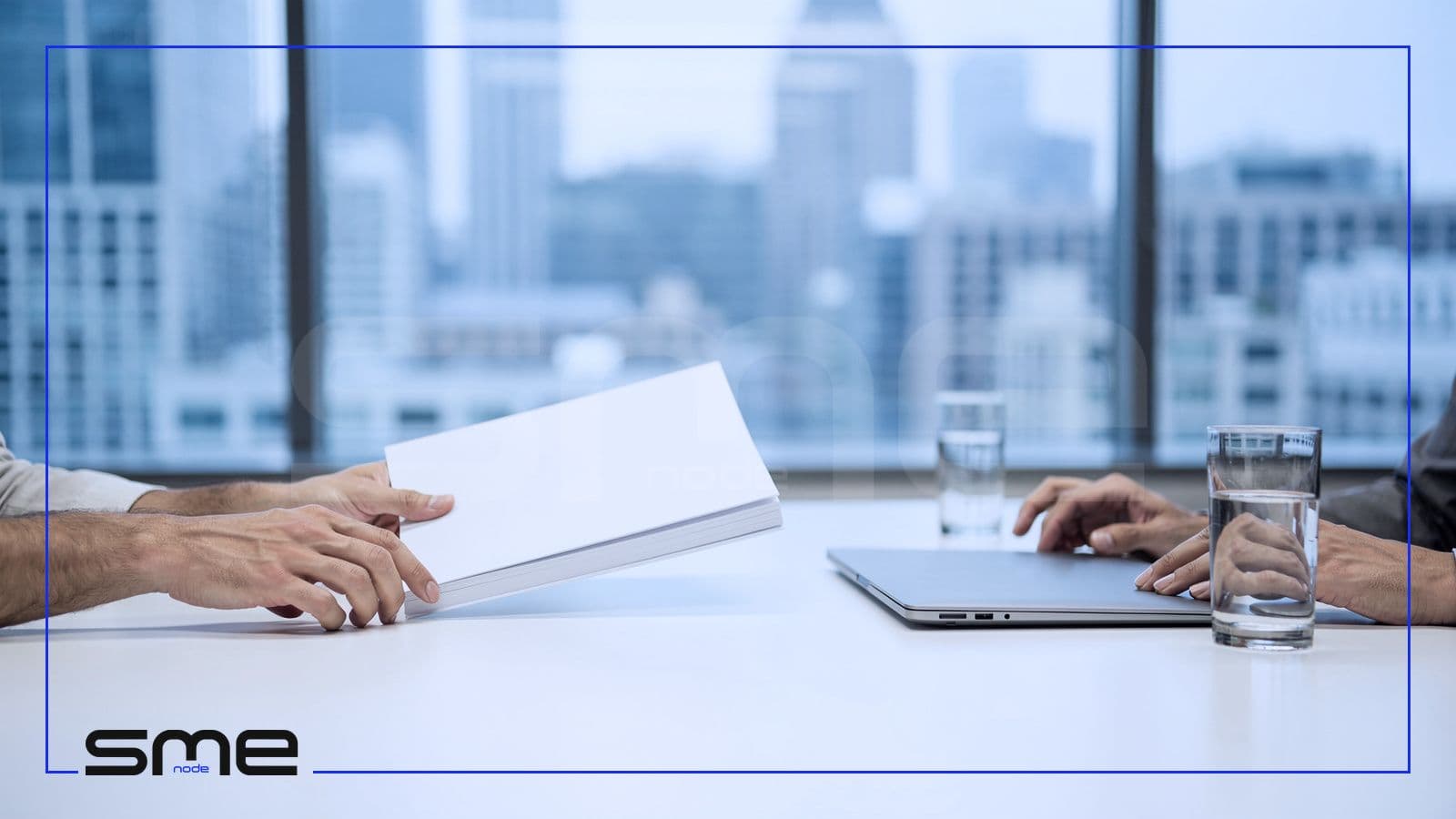Across a meeting table by a city-view window, one person slides a thick bound document toward another, a vendor handing its SOC 2 report to a Canadian buyer