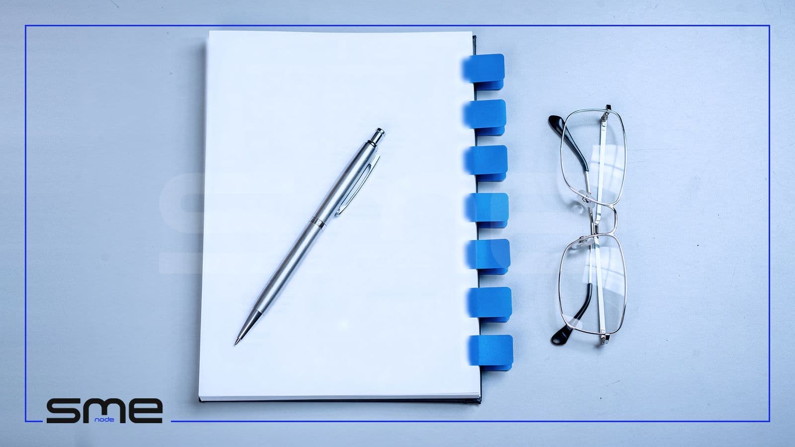 A bound agreement with seven blue tabs on its edge, a pen and reading glasses on a grey desk, the clauses to write into a vCIO or fractional CIO agreement
