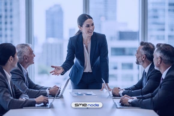 An IT director presenting a three-year technology roadmap to four board members around a table in a bright Toronto office